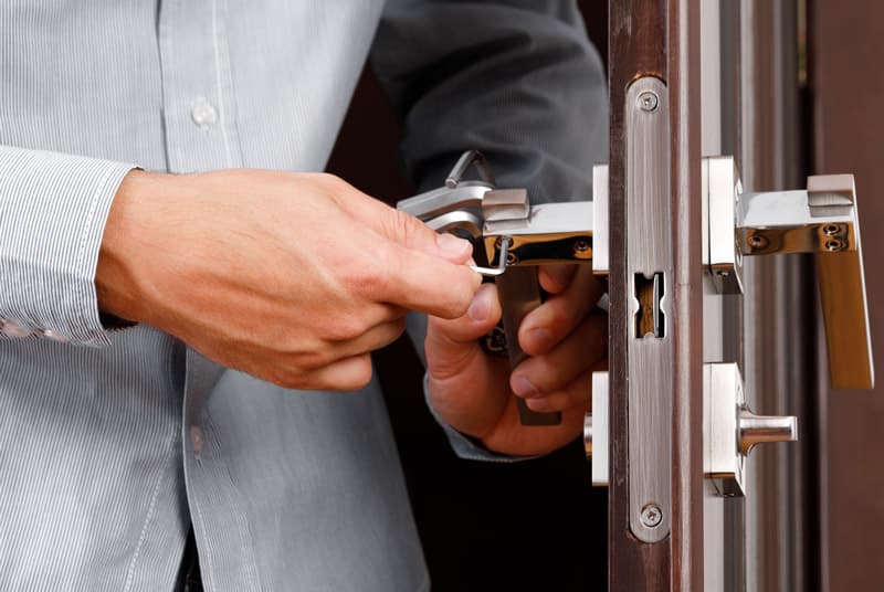 locksmith checking front door lock security